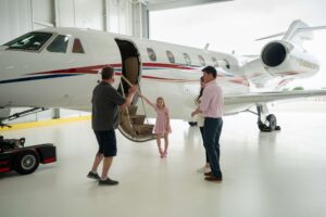 Dave Koch directing private jet production shoot with talent and crew