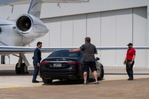 Mercedes car positioned on airport tarmac as a prop with talent on jet photo shoot
