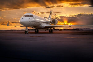 Private jet on the tarmac at sunset with dramatic sky and mountain silhouette, photographed at Las Vegas airport for premium aircraft marketing.