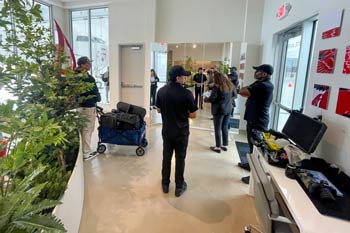 Behind-the-scenes view of an aircraft photography production crew preparing gear inside a hangar facility.