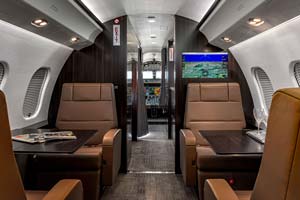 Business jet cabin interior looking forward toward cockpit, photographed by AeroMedia on the ramp at Farnborough Airport, Hampshire, United Kingdom
