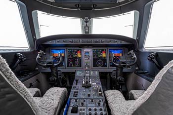 Aircraft photographer in Bozeman Gulfstream G150 cockpit with full glass avionics suite photographed at Bozeman Yellowstone International Airport.