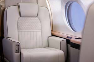 Gulfstream G550 luxury jet cabin seat and window-side ledge photographed by AeroMedia inside a private hangar at London Gatwick Airport, England