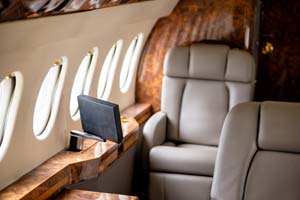 Luxury business jet cabin with dual seating and window line detail photographed by AeroMedia inside a private hangar at London Biggin Hill Airport, United Kingdom