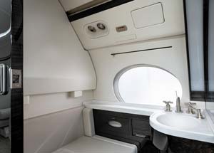 Luxury private jet lavatory interior with sink and window detail, photographed by AeroMedia inside a private hangar at Nice Côte d’Azur Airport, France