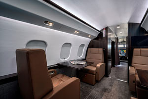 Executive jet cabin at Seletar Airport in Singapore with brown leather seating and forward cockpit view"