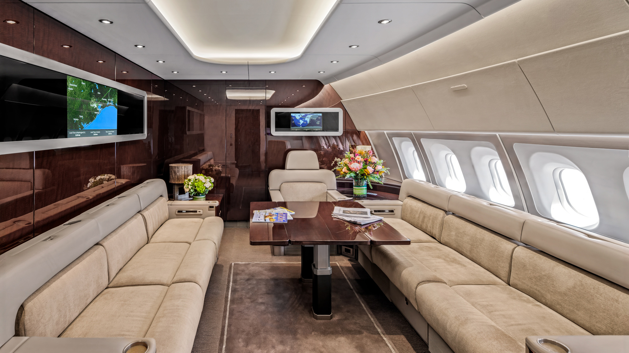 Luxury suite aboard an ACJ A340 in Scottsdale, with twin flat beds, champagne service, and wood-trimmed VVIP furnishings photographed by Dave Koch.