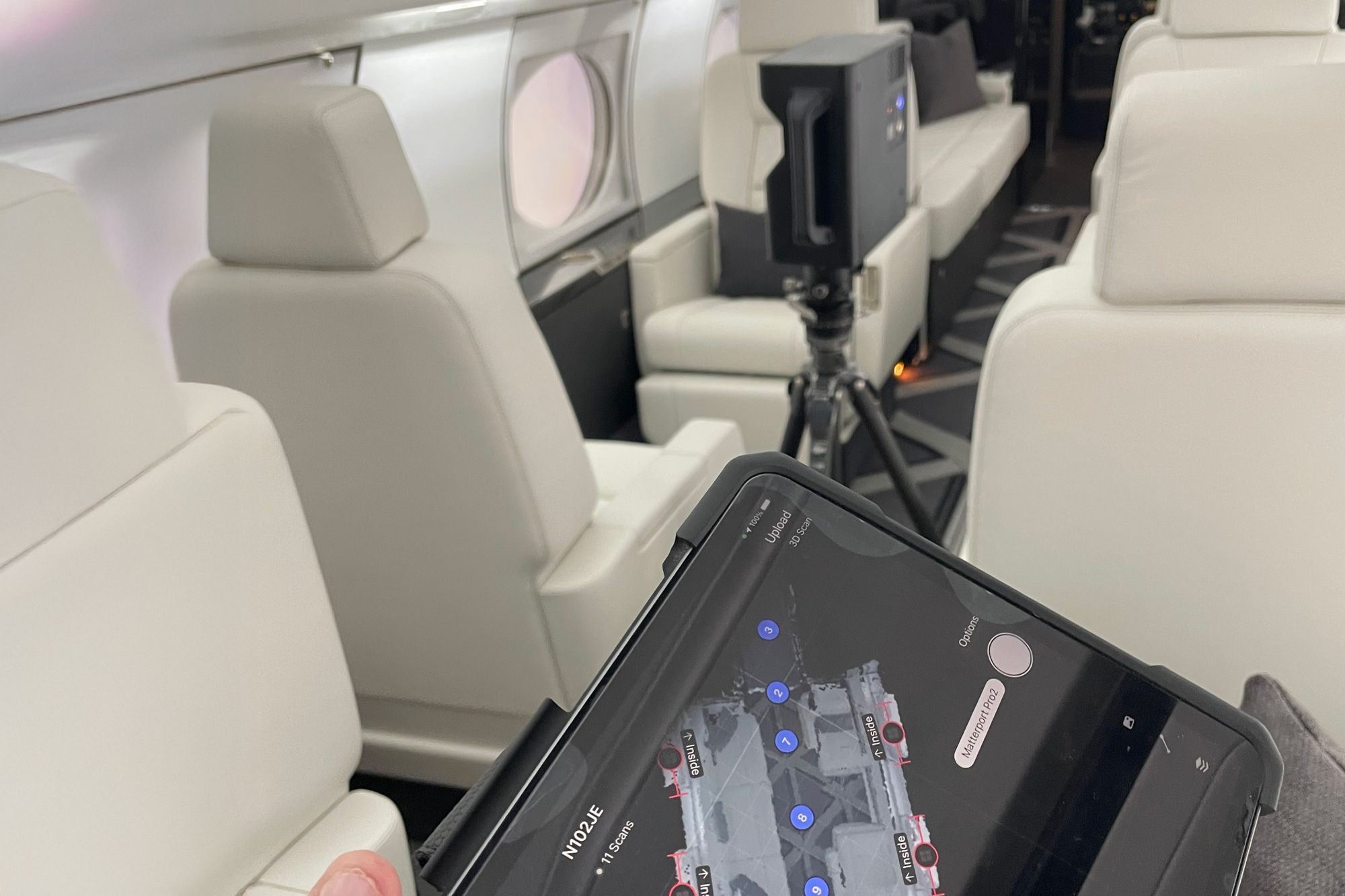 ive Matterport interface on iPad during private jet interior scan in Detroit, showing cabin seating and real-time scan tracking.