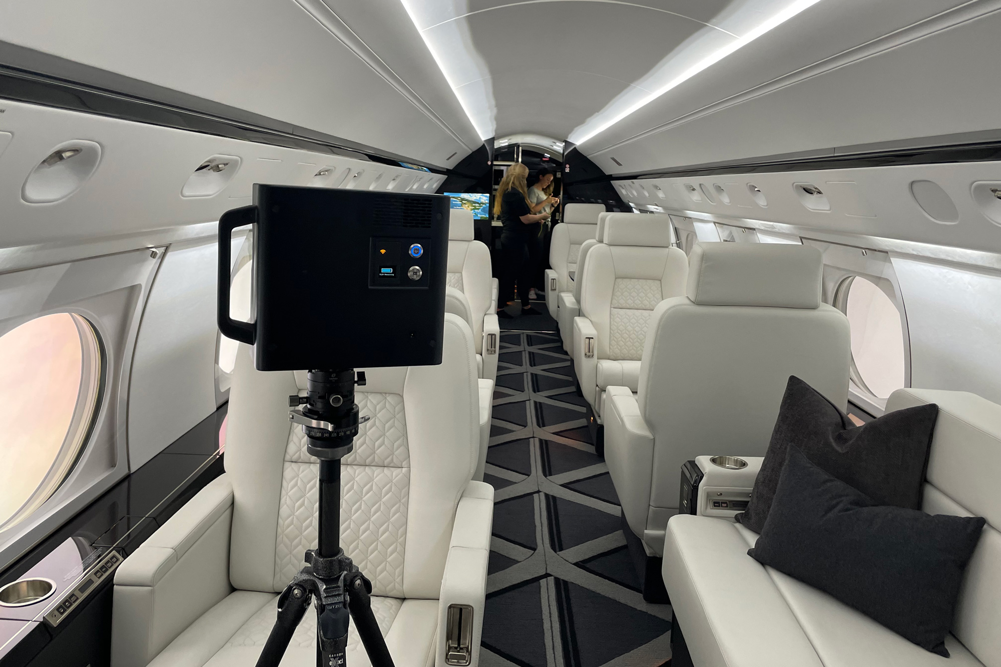 Luxury private jet interior in Detroit photographed during an active 3D Matterport scan, with camera setup visible and cabin seating showcased.