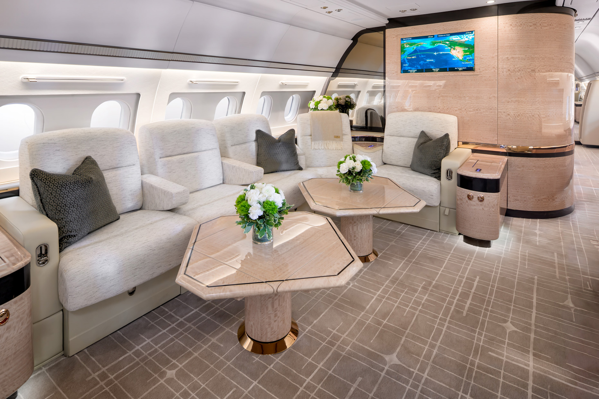 ACJ A319 cabin photographed in Ontario, California by Dave Koch, with floral-topped tables, symmetrical recliners, and inflight display panel.