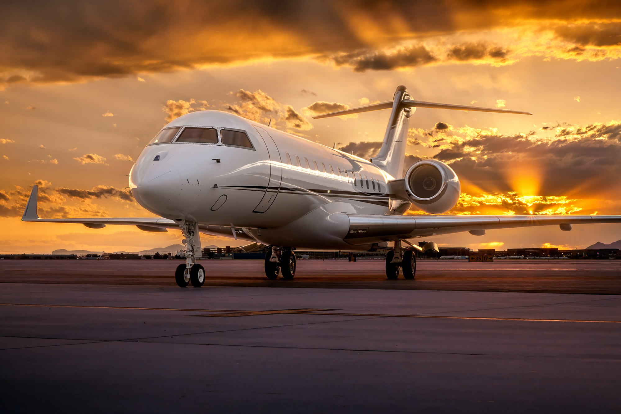 Exterior private jet photographed by Dave Koch at Salt Lake City International Airport, showing a large-cabin business jet staged on the ramp at sunset.”