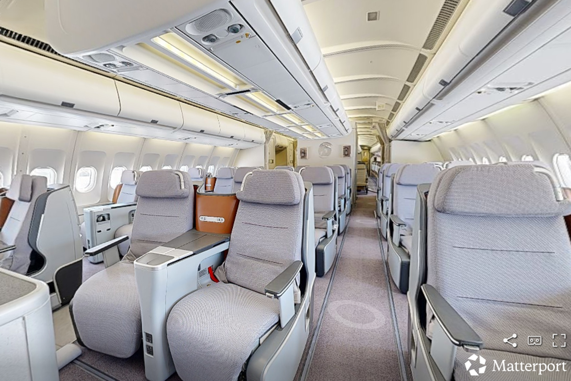 Business-class layout of a wide-body aircraft photographed in Tucson, captured during a Matterport 3D scan by Dave Koch.