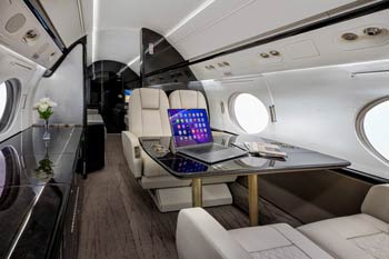 Luxury private jet galley with premium wood cabinetry and espresso station photographed in Doha at Hamad International Airport