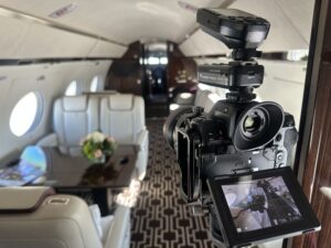 Professional DSLR camera positioned inside Gulfstream G650 cabin, focused on capturing premium interior details and lifestyle staging.