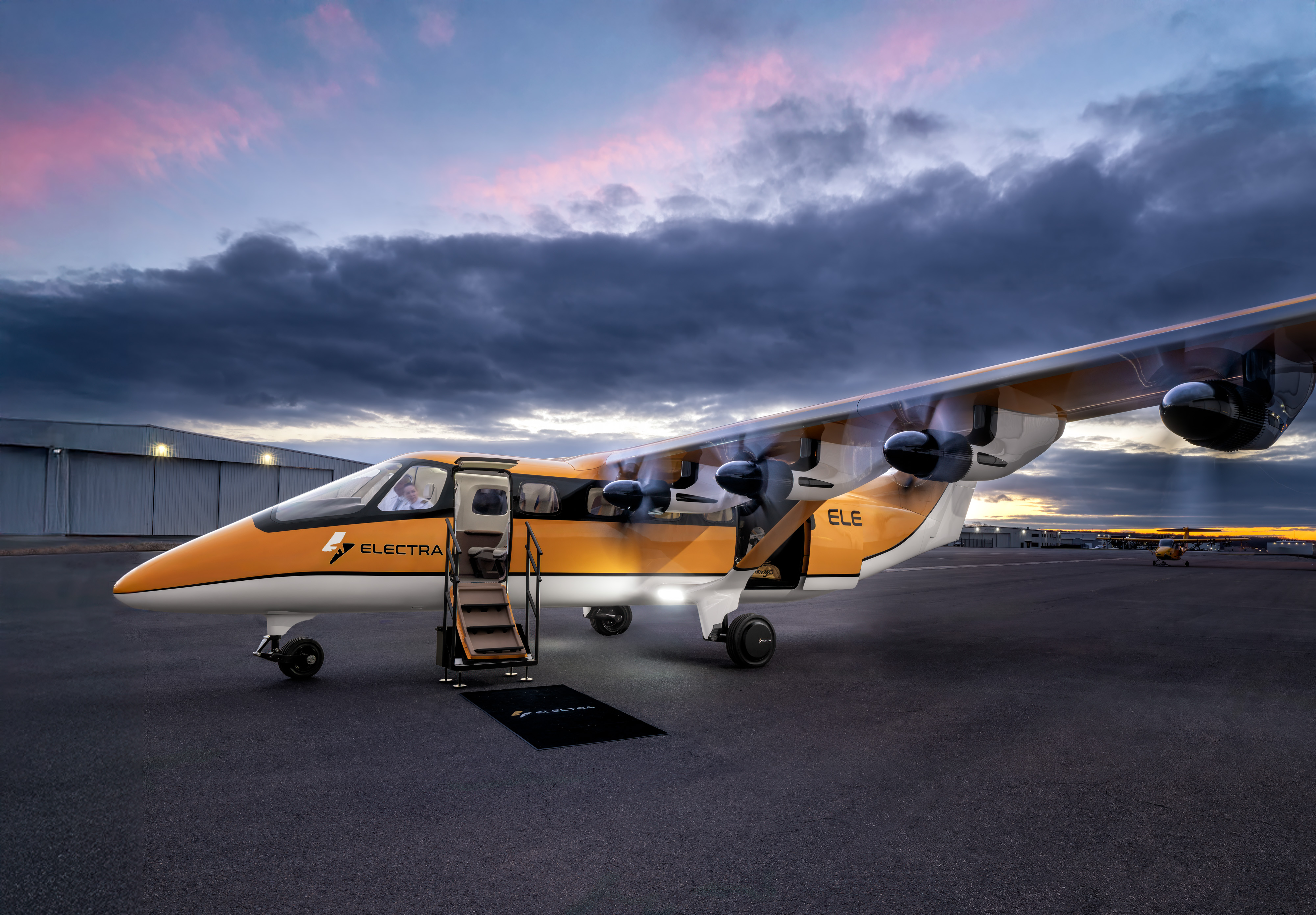 The Electra EL-9 at sunrise — engines spinning, stair down, bathed in soft blue and pink hues.